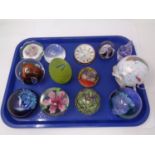 A tray containing assorted glass paperweights including Caithness together with an art glass bauble.