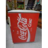A Coca-Cola under bench fridge.