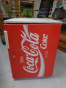 A Coca-Cola under bench fridge.