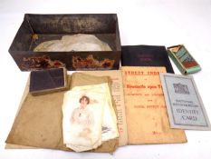 A tin containing a ration book, national registration ID card, cigarette silks and cards,