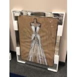 A picture depicting a dress in a mirrored frame, 73 x 92 cm.