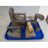 A tray containing a cast iron cobblers last together with a pair of flat irons.