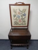 An oak flap sided two tier tea trolley (lacking casters) together with a mahogany framed tapestry