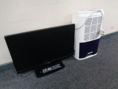 A Logik 21 inch TV DVD with remote together Meaco dehumidifier.