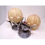 Two Art Deco chrome table lamps with glass shades.