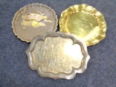 An Indian etched brass tray together with two others