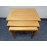 A nest of three 20th century teak tables.