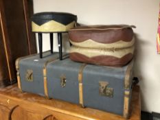 An early 20th century wooden bound trunk together with two 20th century footstools.