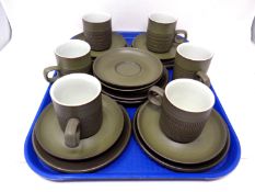 A tray containing six Denby coffee trios.