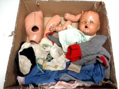 A box containing a vintage doll (AF) together with a quantity of dolls clothes.