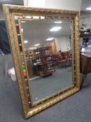 A Victorian style decorative gilt framed bevel edged overmantel mirror 155cm by 124cm