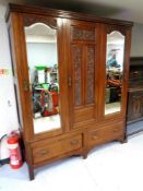 A 19th century mahogany triple door wardrobe fitted with two drawers