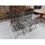A set of six wrought iron high backed dining chairs