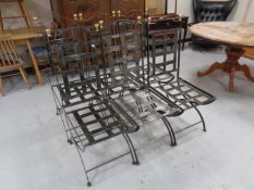 A set of six wrought iron high backed dining chairs