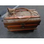 A tin trunk and a copper and brass hunting horn.