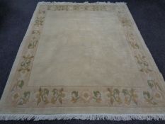 A fringed woolen Grutman Oriental style carpet on beige ground, 232 x 192 cm.