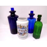 Four vintage chemist's bottles and jars.