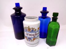 Four vintage chemist's bottles and jars.