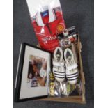 A box containing sporting memorabilia including a pair of boots signed by Stewart Broad,
