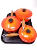 Three graduated Le Creuset cast iron sauce pans with lids (as new)