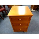 A Stag three drawer bedside chest in teak finish