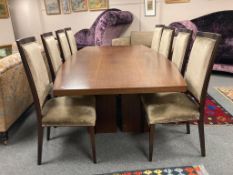A contemporary nine piece dining room suite comprising of tonneau-shaped hardwood table 130 cm x