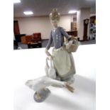 A Lladro figure - Lady with ducks, together with a further Lladro figure of a duck.