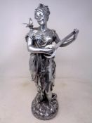 A silvered figure of a lady playing a lute
