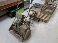 A vintage Atco self drive petrol mower with seat attachment,