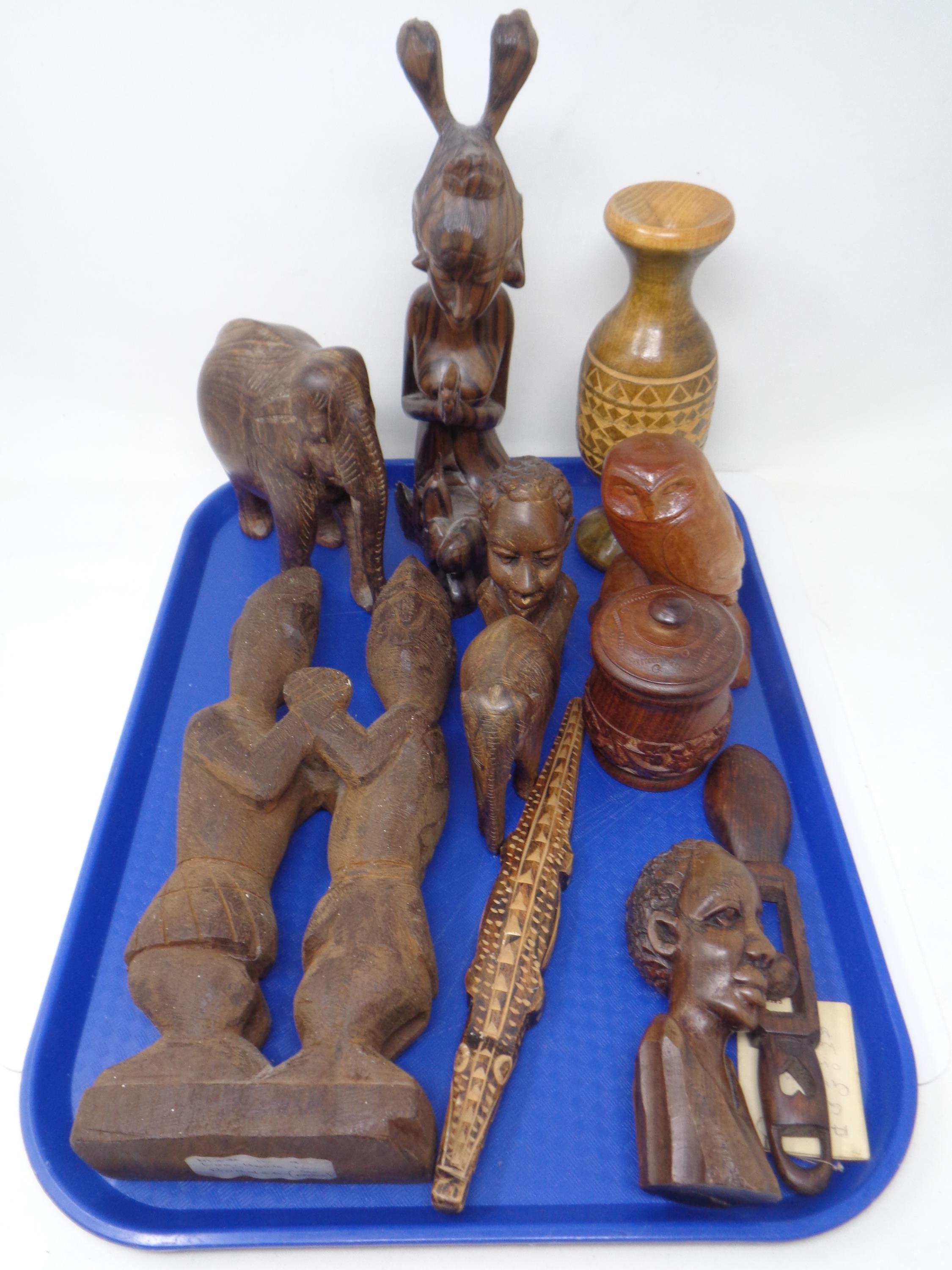 A tray containing tourist carvings.