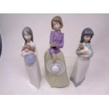 A Nao figure - Girl with bird in hand, together with two further Nao figures.