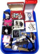 A tray containing a quantity of assorted costume jewellery and wristwatches.