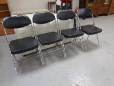 A set of four tubular metal folding kitchen chairs together with a disability walking aid