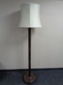 An oriental style carved beechwood standard lamp with shade