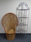 A folding metal five tier corner whatnot stand together with a wicker peacock chair.