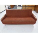 A 20th century teak-armed bed settee.