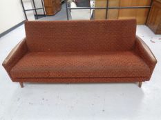 A 20th century teak-armed bed settee.