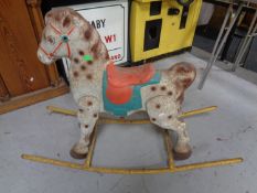 A mid-20th century tin plate rocking horse.