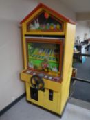A 20th century Ol' McDonald coin operated egg arcade machine.