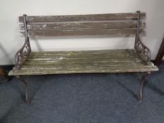 A cast iron frame wooden slatted garden bench.