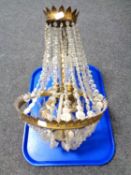 An antique brass and cut glass chandelier.