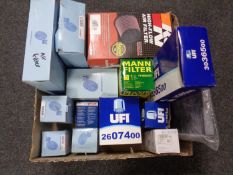 A box containing assorted car filters including air filters, oil filters, fuel filters etc.