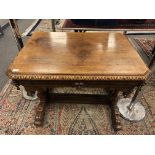 An early Victorian carved oak library table fitted a drawer,