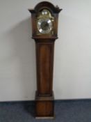 A Tempus Fugit granddaughter clock with brass dial.