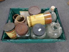 A crate containing vintage kitchen storage jars and tins, sweet jars, brewery bottles.