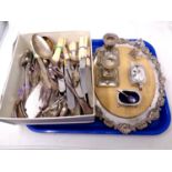 A box containing a quantity of stainless steel and silver plated cutlery, serving spoons, ladles,