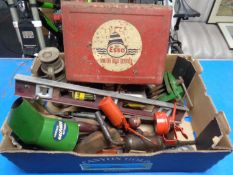 A box containing vintage hand tools, bottlejack, oil lamp,