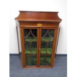 A 19th century inlaid mahogany shaped display cabinet (lacking stand).