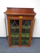 A 19th century inlaid mahogany shaped display cabinet (lacking stand).