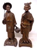 A pair of Japanese cast metal figures of a lady and gentleman